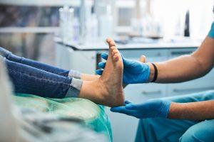 Doctor examining persons foot