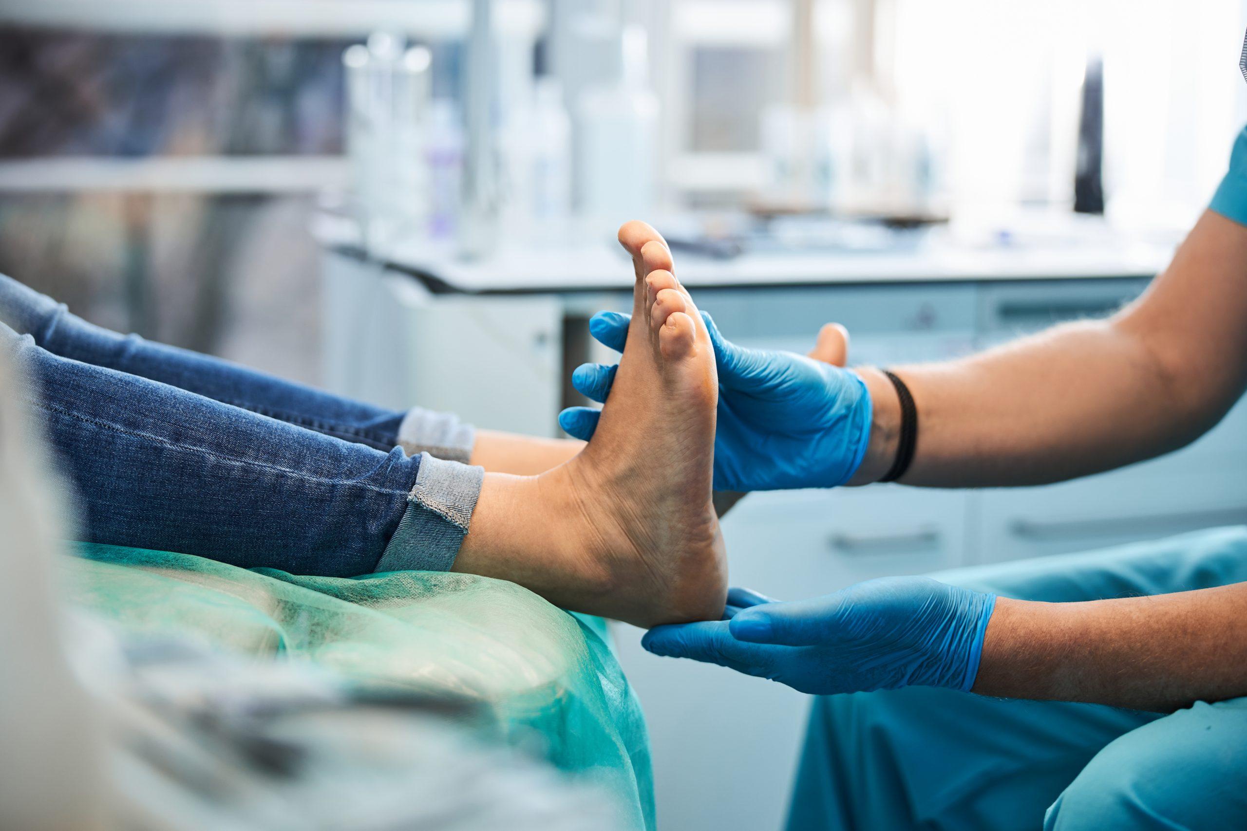 Doctor examining persons foot