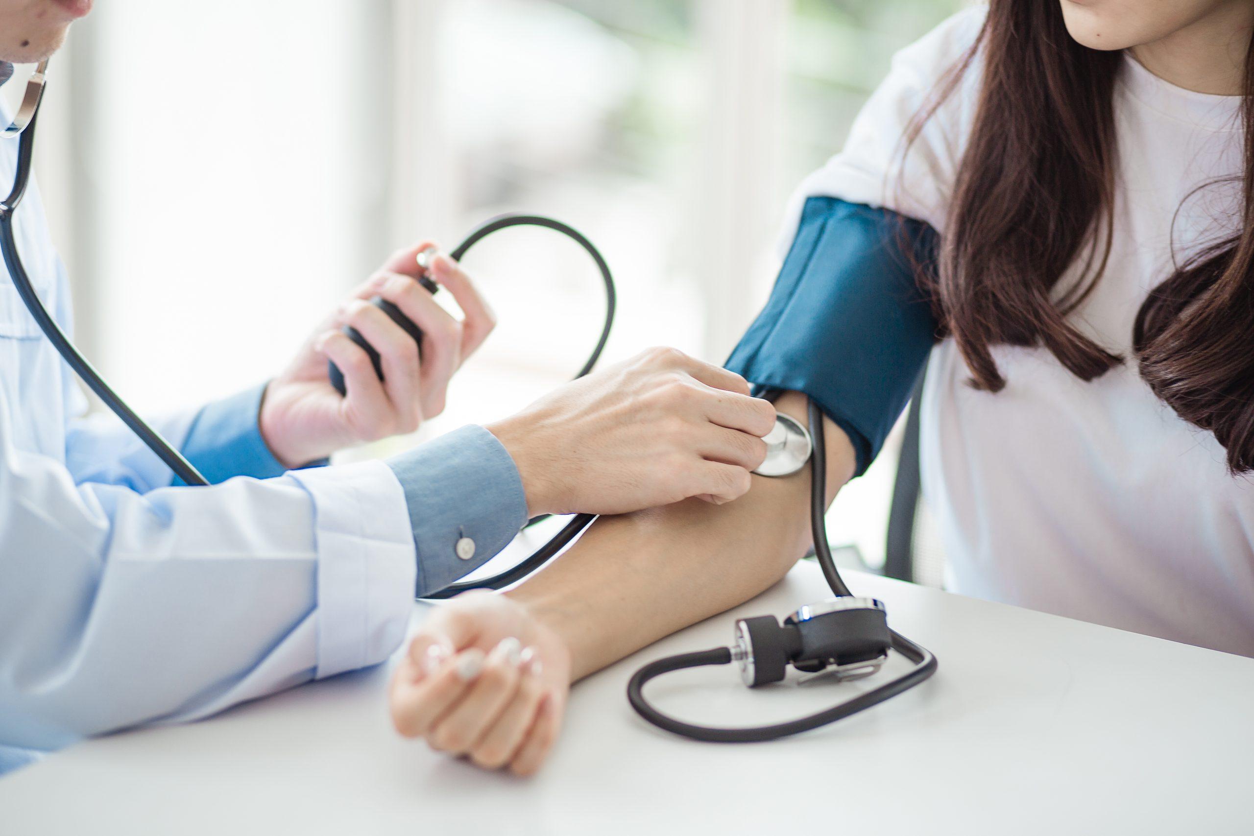 Doctor taking blood pressure of patient