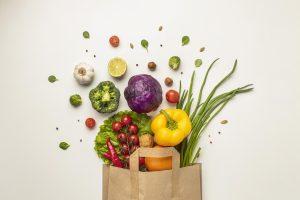 Paper bag overflowing with fruits and vegetables