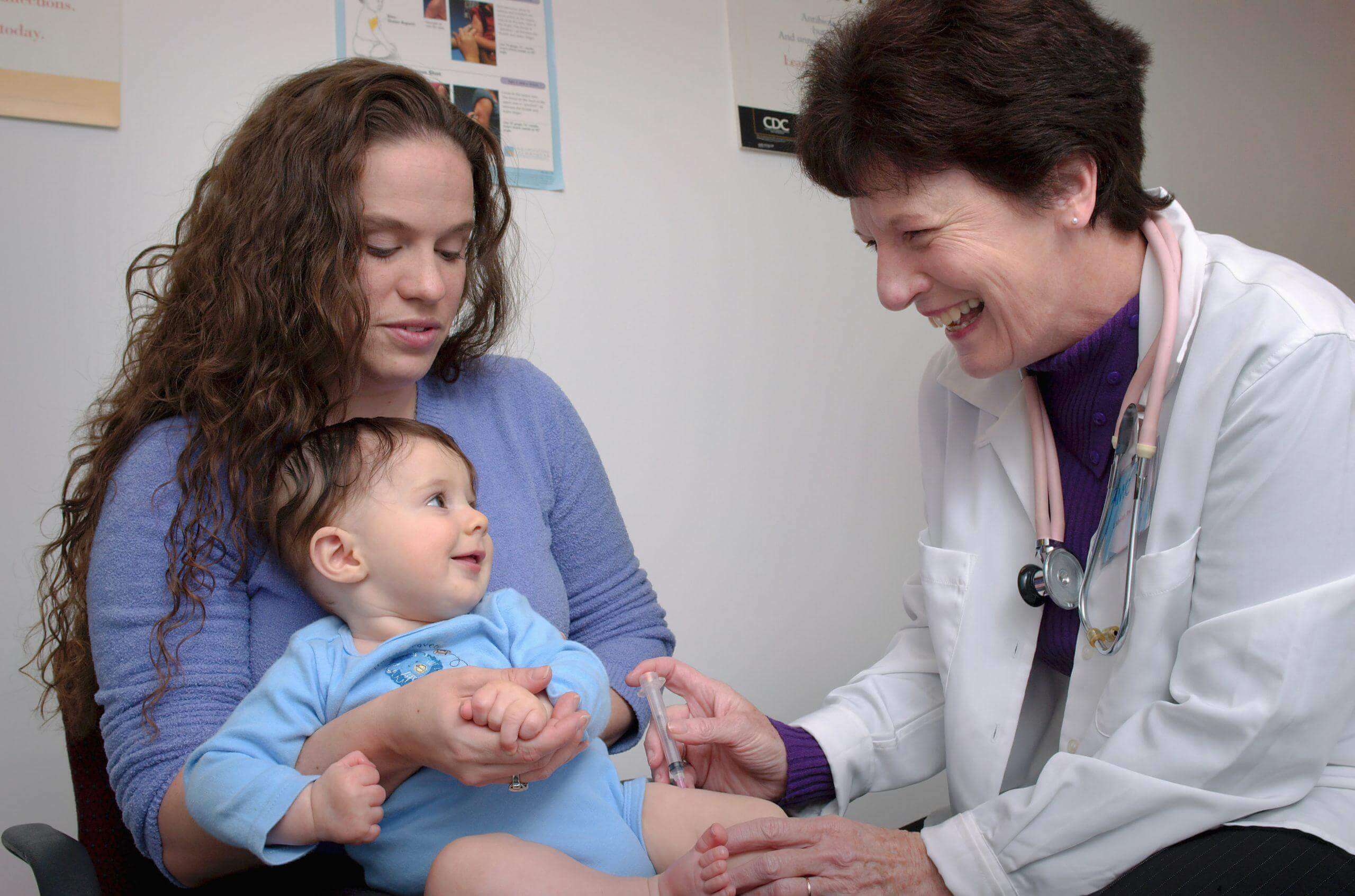 Medical professional holding woman's shoulders in healthcare facility in California